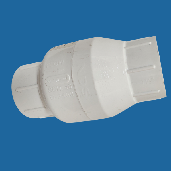 A white plastic TAS Swing Check Valve on a blue background, designed to control water pressure and prevent backflow.