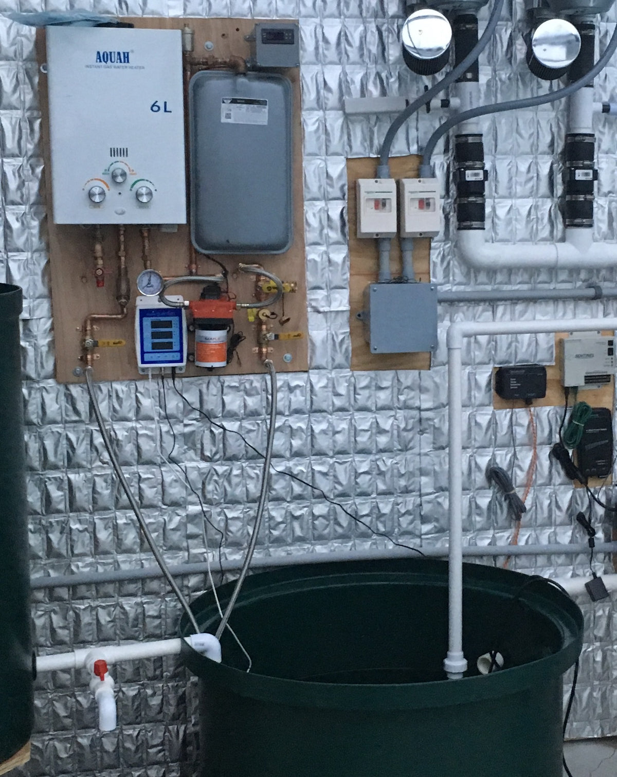 TAS AquaHeat Propane or Natural Gas Fired Heating System, a water treatment system, utilizes pipes and pumps to ensure efficient heating. This advanced system operates using natural gas, providing an eco-friendly solution for maintaining optimal water temperature in any room.