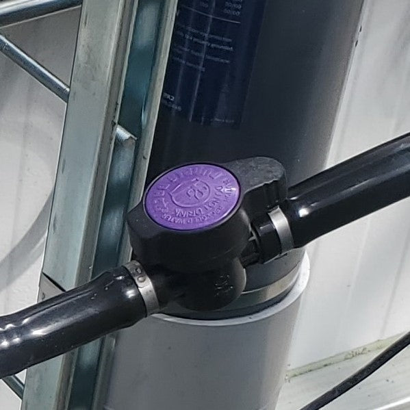A TAS Ball Valves-Barb x Barb attached to a metal pipe.