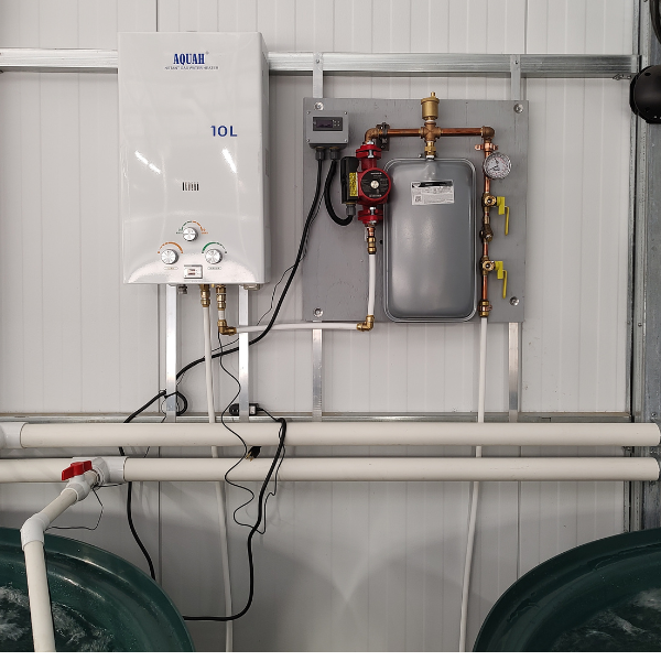 An AquaHeat Propane or Natural Gas Fired Heating System, powered by natural gas, is installed in a garage. (Brand Name: TAS)