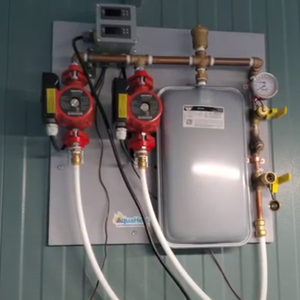 A TAS AquaHeat Propane or Natural Gas Fired Heating System, with two valves attached to it, provides reliable heating through the AquaHeat system.