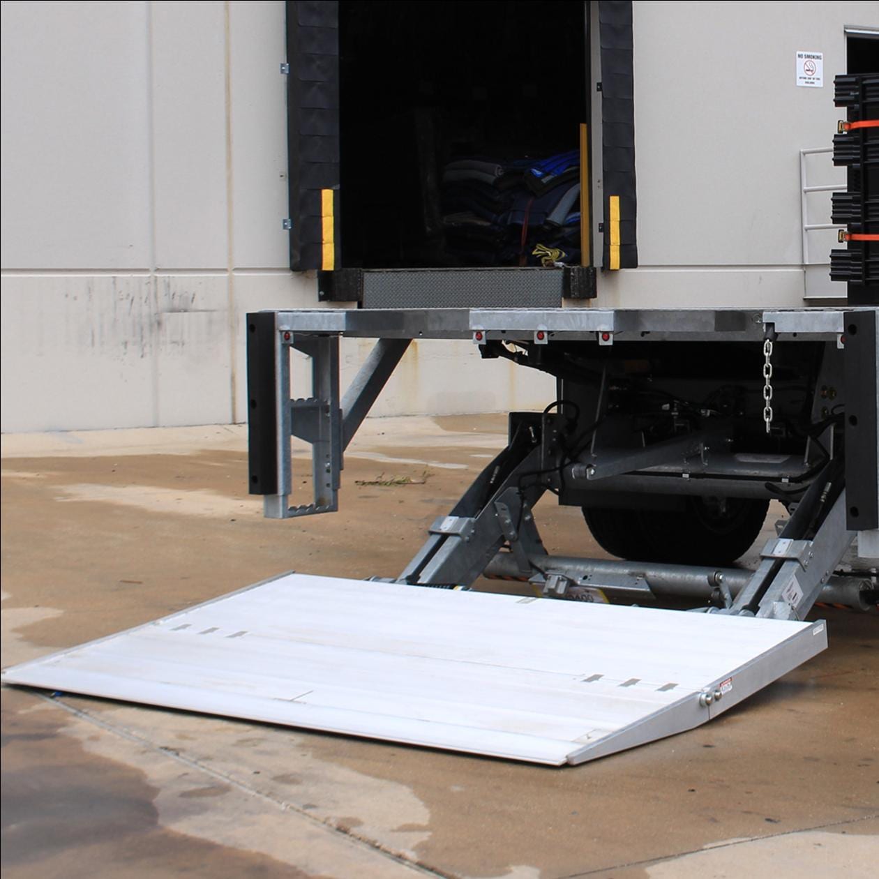 A Go Green Aquaponics Liftgate Delivery truck with a ramp on it.