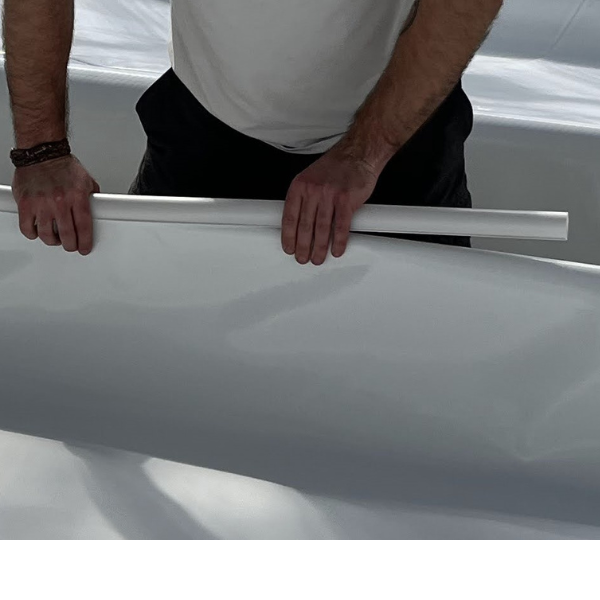 A person applying Snap Clamps for Duraskrim Liner from Aquaponics For Life using a squeegee.