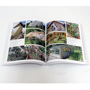 A beautifully illustrated book showcasing the GGAAZN Year-Round Solar Greenhouse design and its stunning integration with a lush garden.
