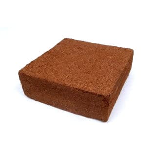 A brown block made from Natures Footprint Worm Factory Coir 650g Brick – 5 Pack on a white background.