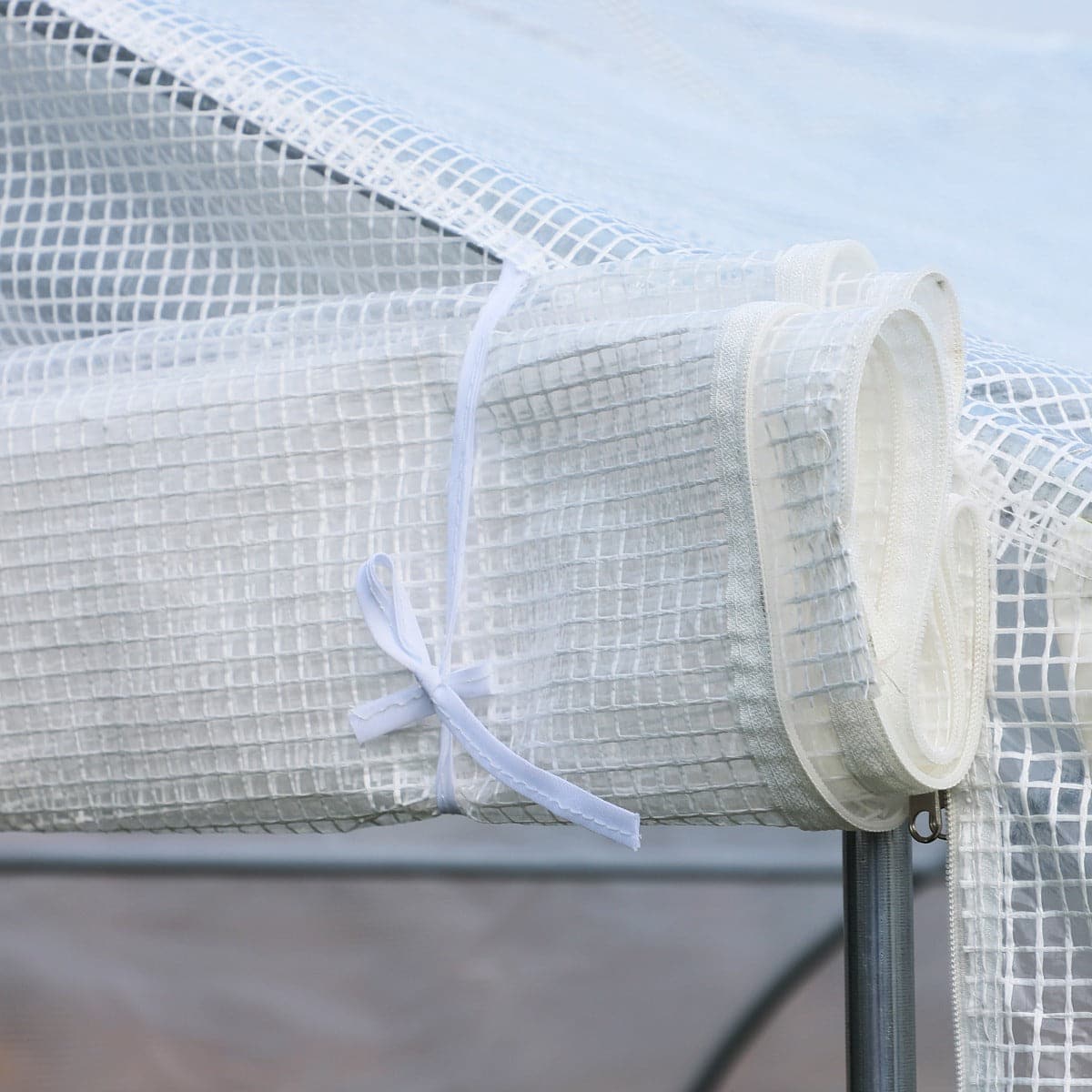 A white netting is attached to the top of an Aosom Outsunny 20&#39; x 10&#39; x 7&#39; Deluxe High Tunnel Walk-in Garden Greenhouse Kit - White.