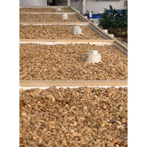 A Dura-Skrim Liner – 6′ Width by Aquaponics For Life creates a durable row of gravel on top of a building.